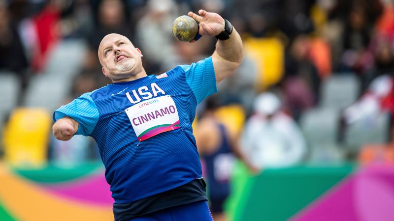 a male Para athlete throws a shot put