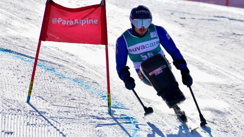 Male sit skier rides down mountain