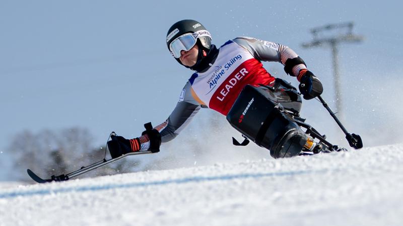 A male sit-skier competing on the snow