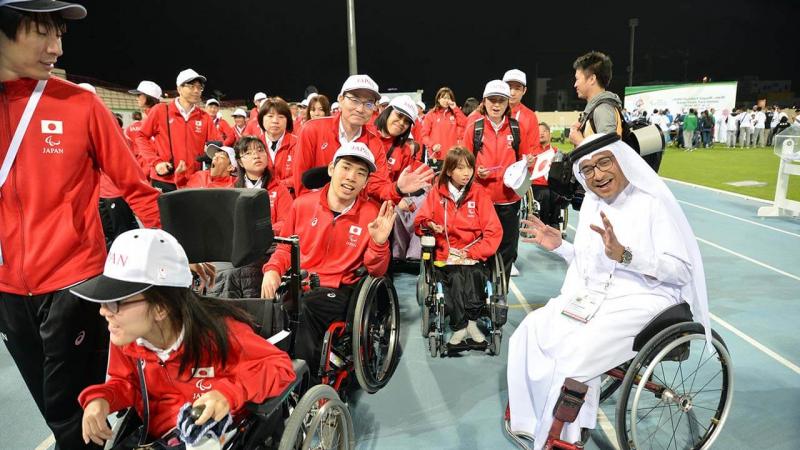 Japan delegation with man in wheelchair smiling with them