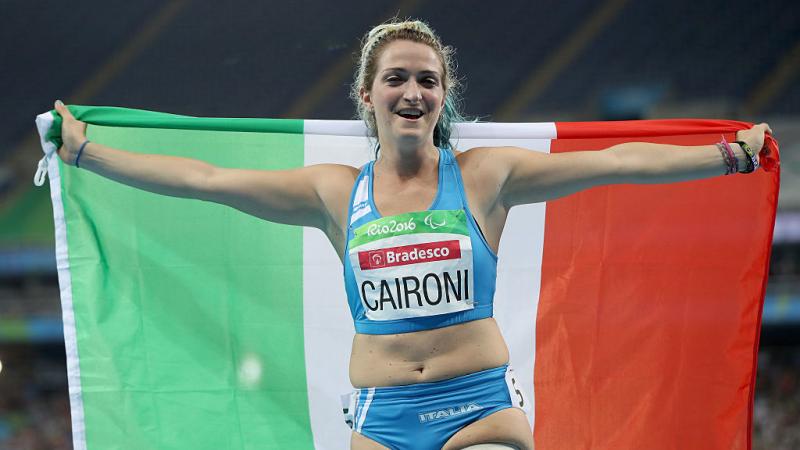 Para sprinter Martina Caironi holding up the Italy flag in celebration 
