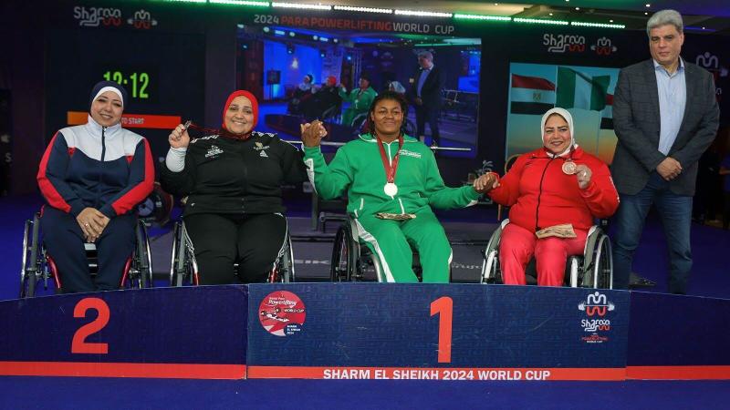 Athletes strike a pose on the podium