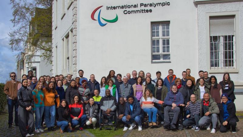 About 60 IPC staff pose for a photo in front of the IPC headquarters in Bonn.