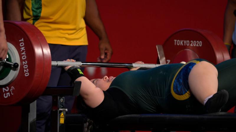 A female athlete lifts weights