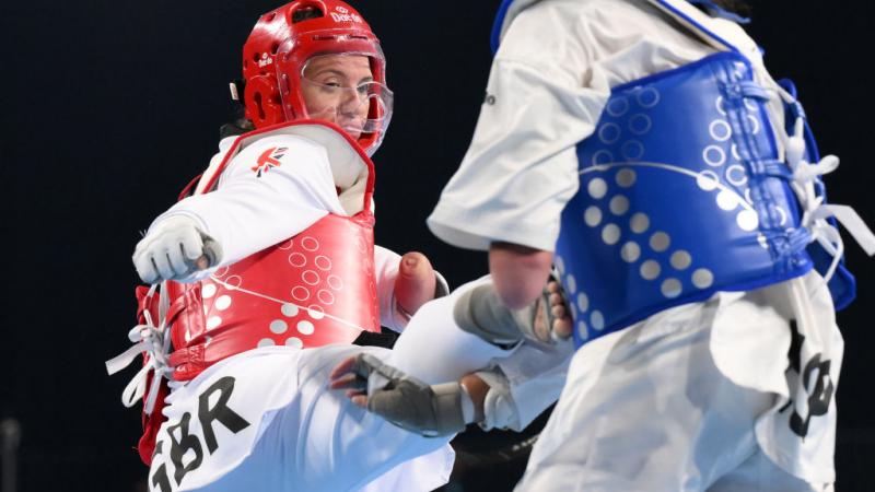 A female athlete kicks her opponent