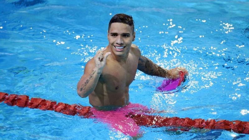 A male Para swimmer competes 