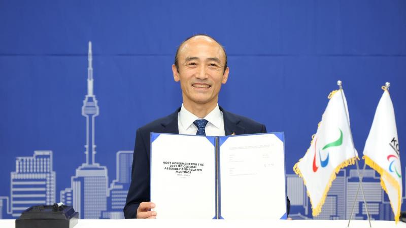 Korea Paralympic Committee President Jin-owan Jung holds a document titled "Host Agreement for the 2025 IPC General Assembly"