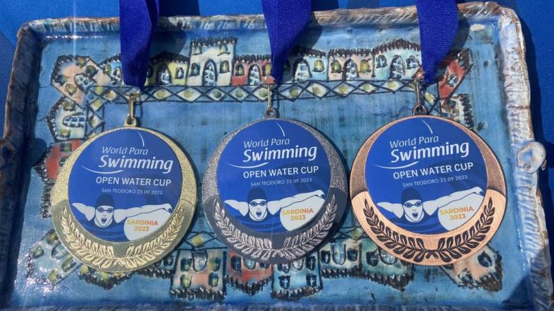 A tray with three medals of the Sardinia 2023 Open Water Cup