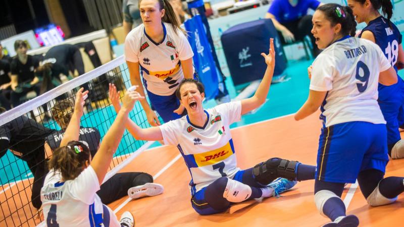 Sara Cirelli, a female sitting volleyball player, celebrates with her teammates.