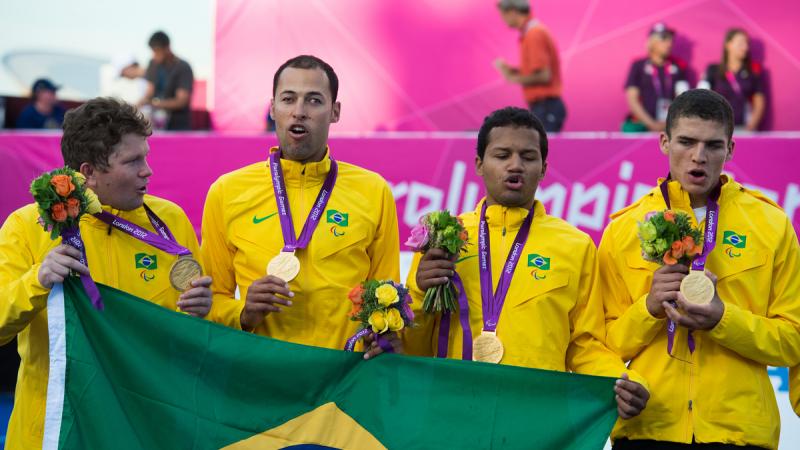 Members of the Brazilian team singing their national anthem during the victory ceremony