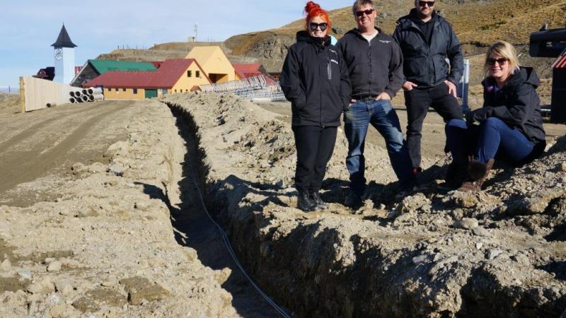 Cardrona general manager, Bridget Legnavsky and Cardrona terrain and snow manager, Dave Collett with Cameron Ross from High Performance Sport NZ and Audi quattro Winter Games NZ sports manager, Iona Bentley next to one of the fibre optic cable channels at Cardrona Alpine Resort 