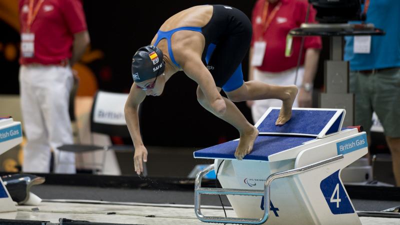 A swimmer starts their race