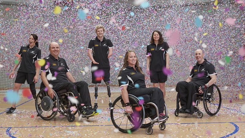 Six people standing and in wheelchairs 