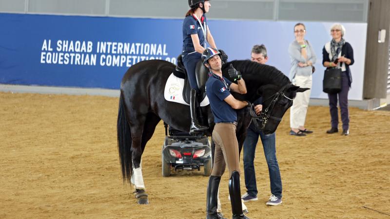 A rider on a black horse