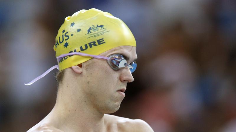 A visually impaired swimmer prepares for a race