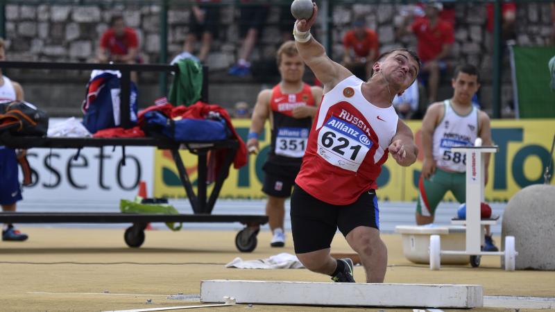 Short statued man doing shot put