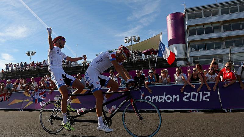 Ivano and Lucca Pizzi of Italy celebrate winning the Men's Individual B Cycling Road Race at the London 2012 Paralympic Games.