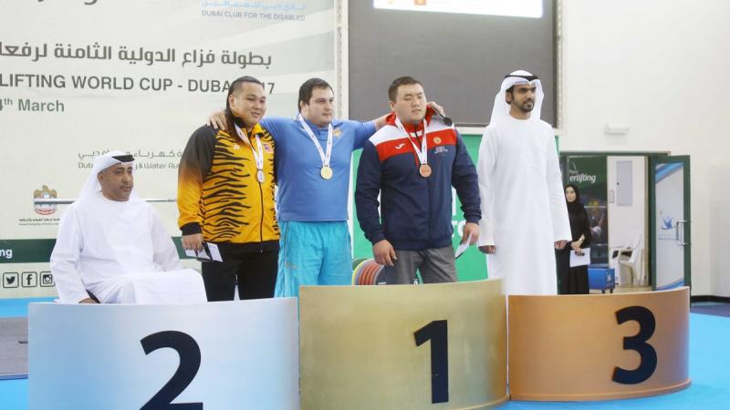 Three men on a podium