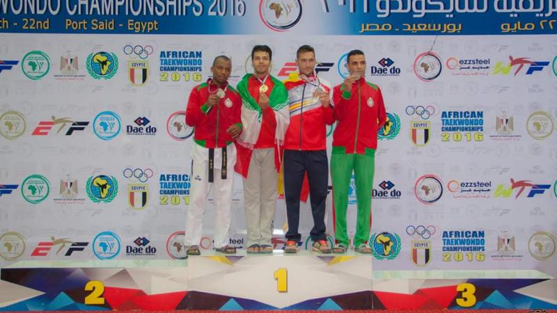 Four men stand on the podium