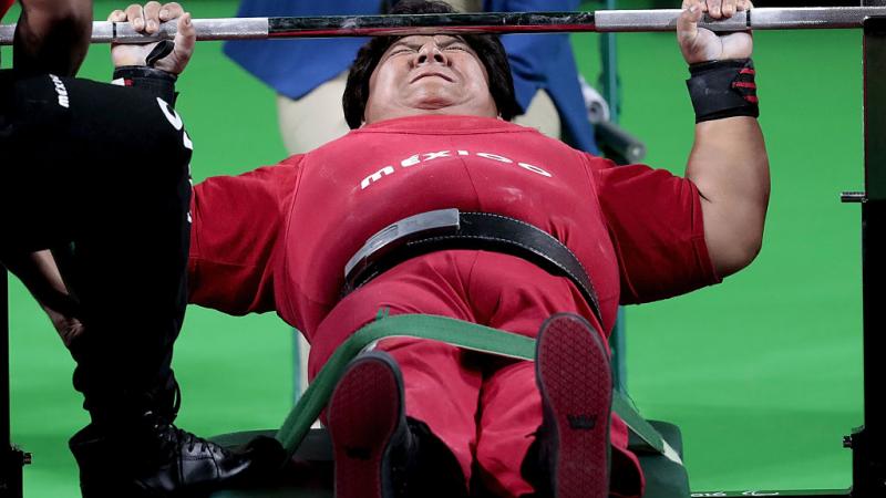 female powerlifter on bench preparing to lift weights