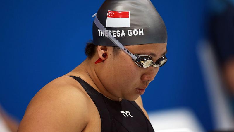 a woman with swimming cap and goggles on