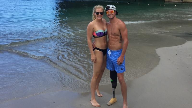 a man and a woman in swimsuits on a beach