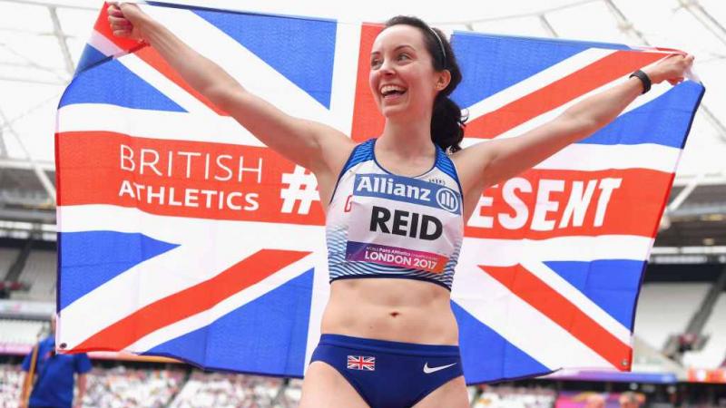 a para athlete holds a British flag