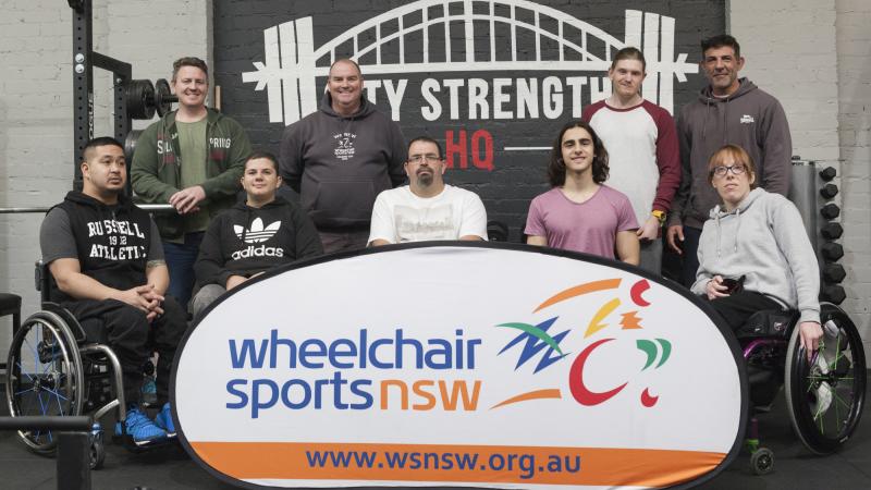 a group of powerlifters pose for a photo