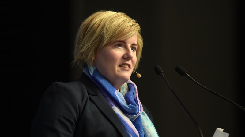 A woman speaks at a podium