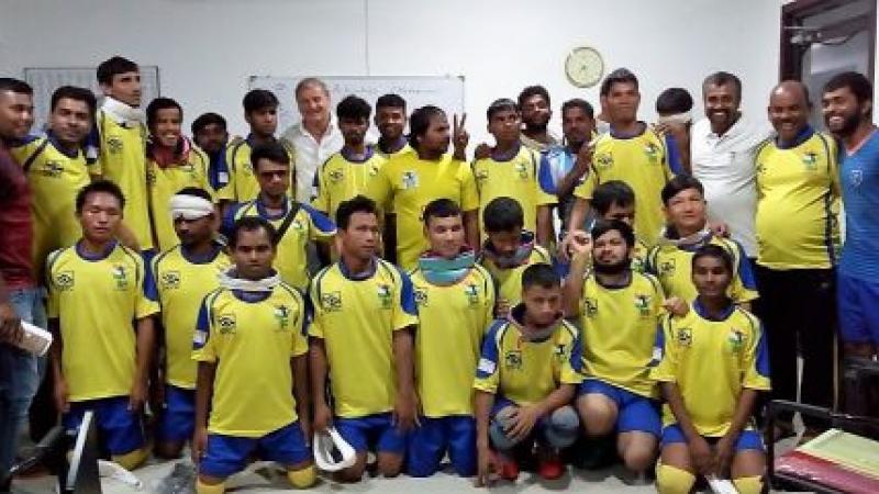 a group of visually impaired athletes smile for the camera