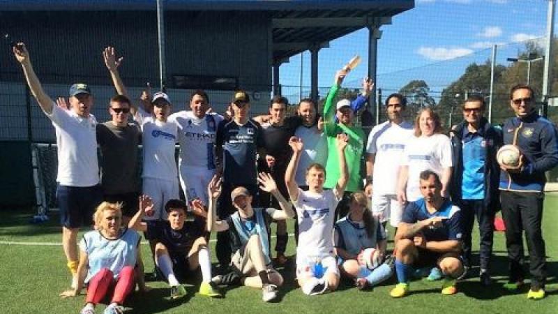 a group of blind footballers smile at the camera