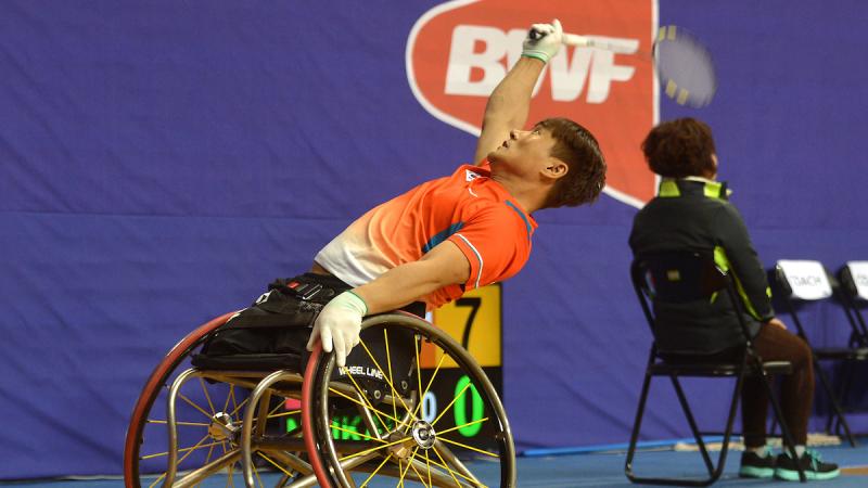 Man in wheelchair playing badminton