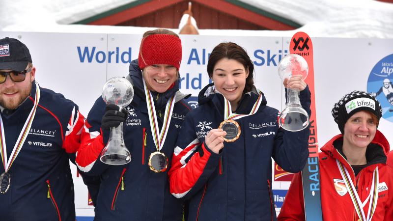 a female vision impaired skier and her guide on the podium