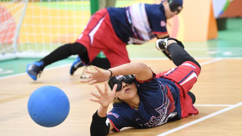 a female goalball player saves a shot