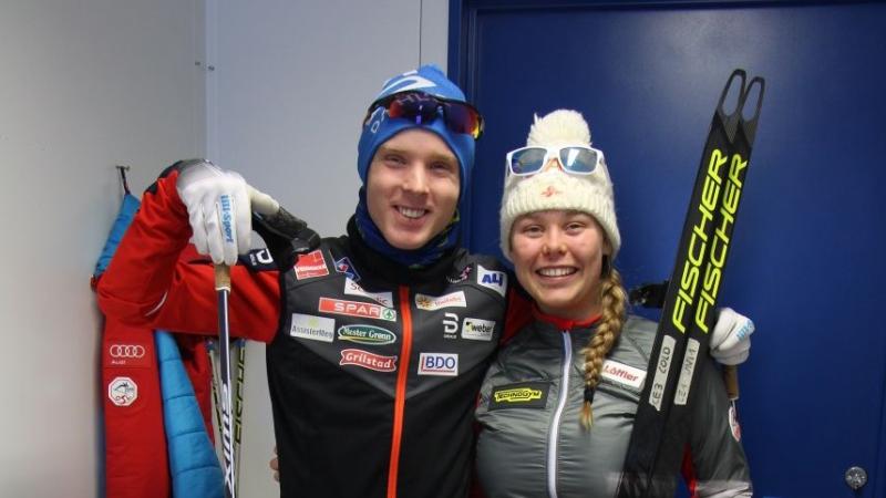a male and female Para Nordic skier smiling together