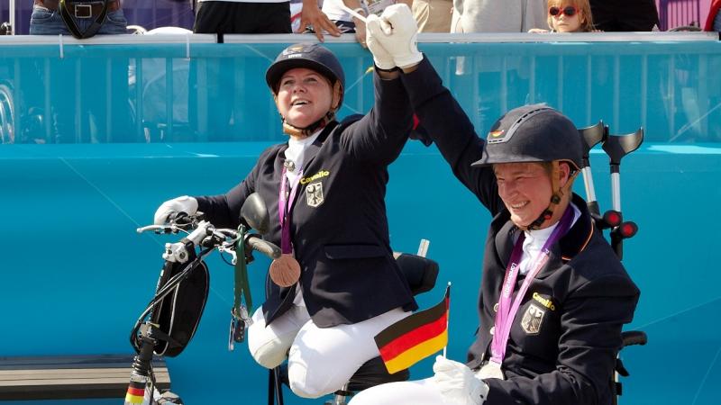 female Para equestrian rider Angelika Trabert celebrates with the German flag and her medal