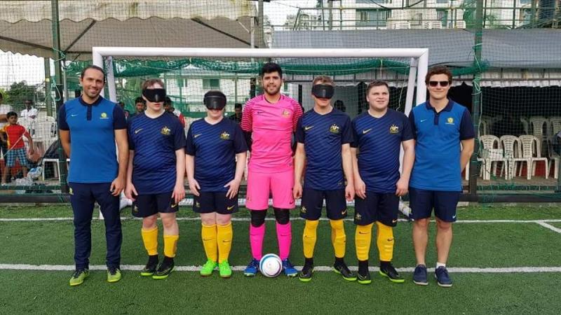 Seven man standing on an artifical turf football pitch