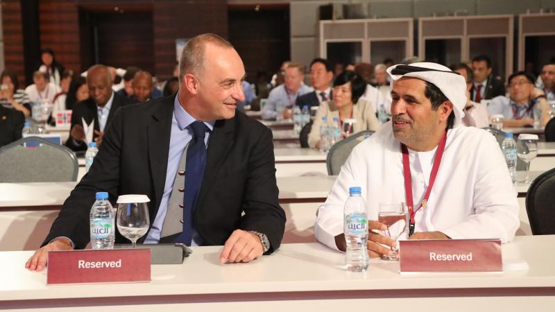 Two men talking to each other at a conference