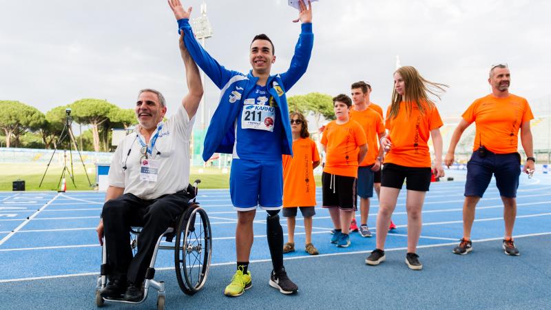 male Para athlete Lorenzo Marcantognini celebrates waving on the podium