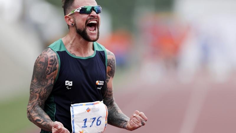 Brazilian sprinter Vinicius Rodrigues screams in joy after a race