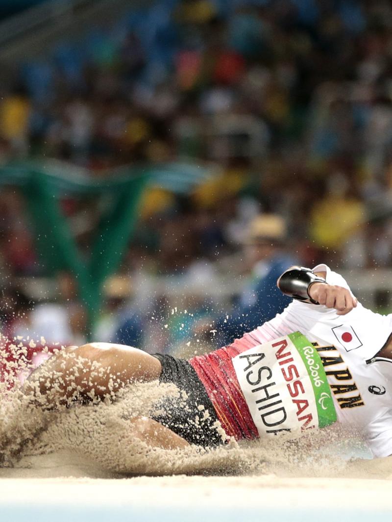 Japanese man completes long jump in sand