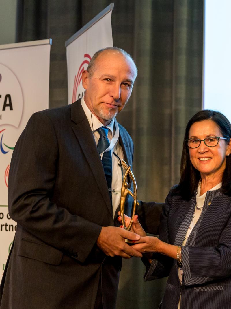 Woman presents man with award