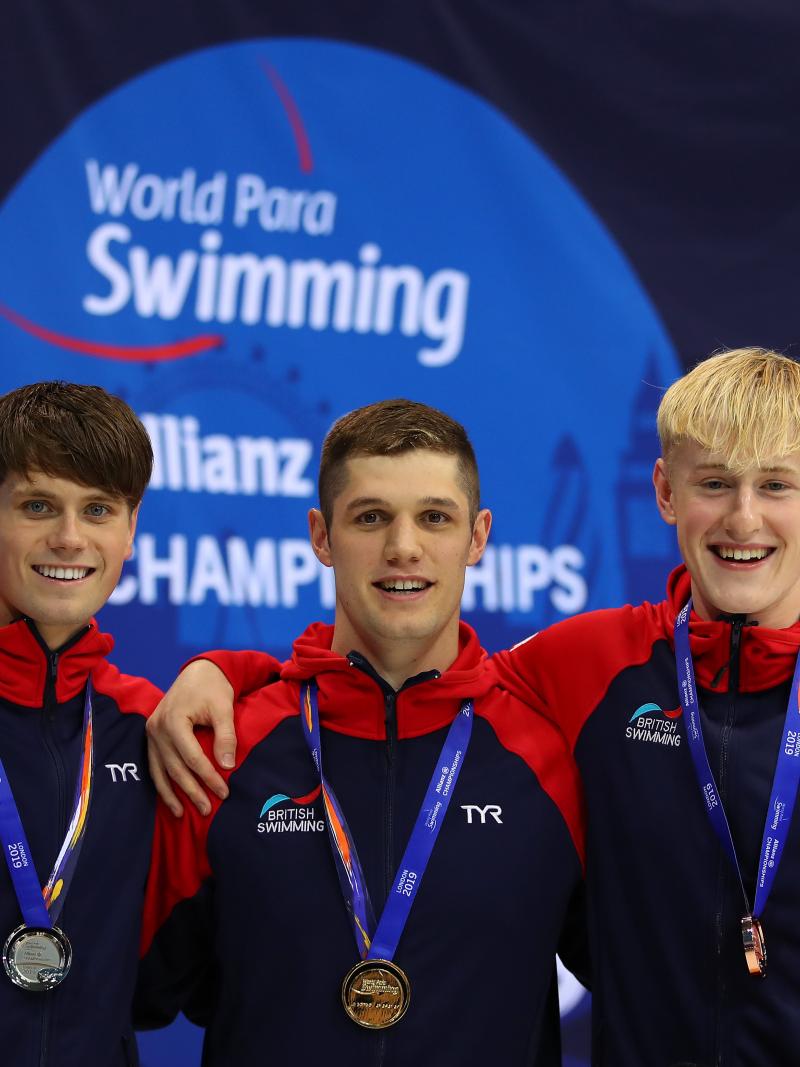 three male Para swimmers on the podium 