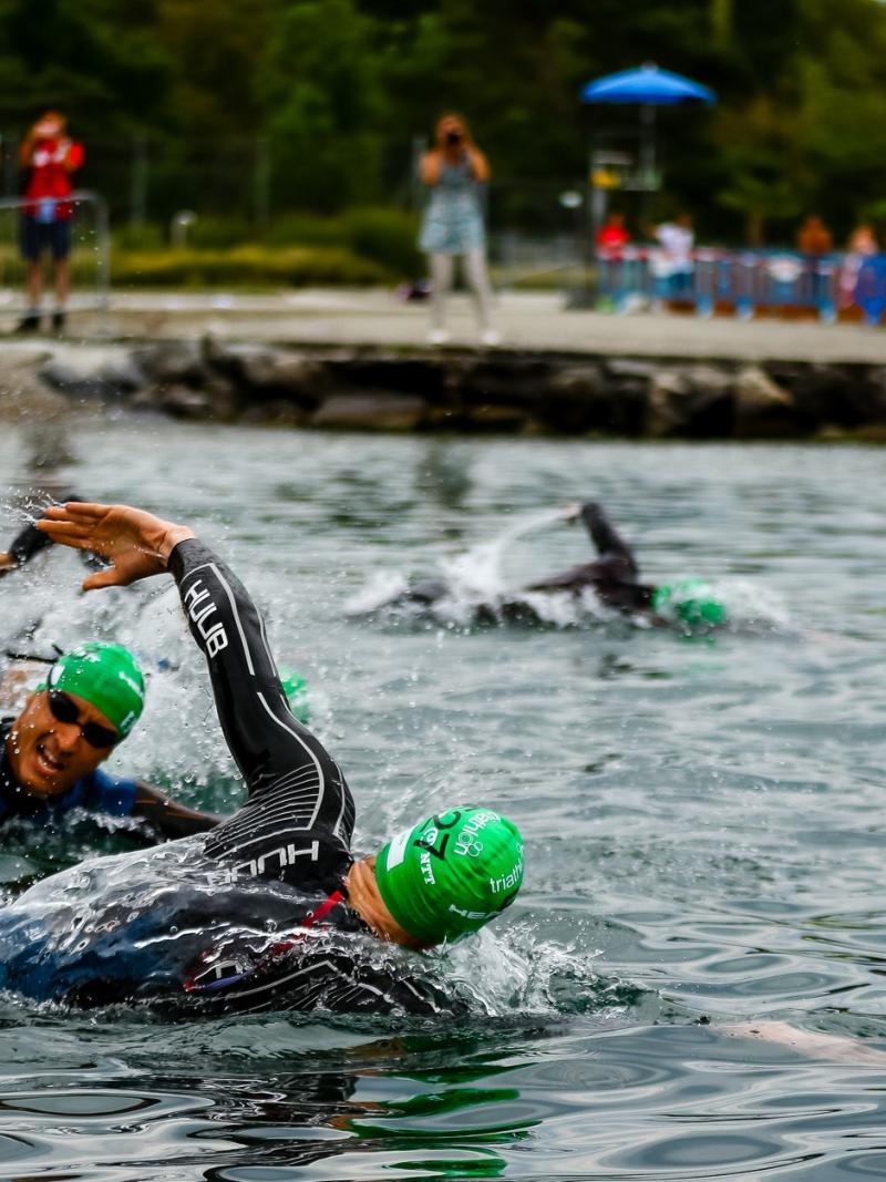 Triathletes swimming in open water