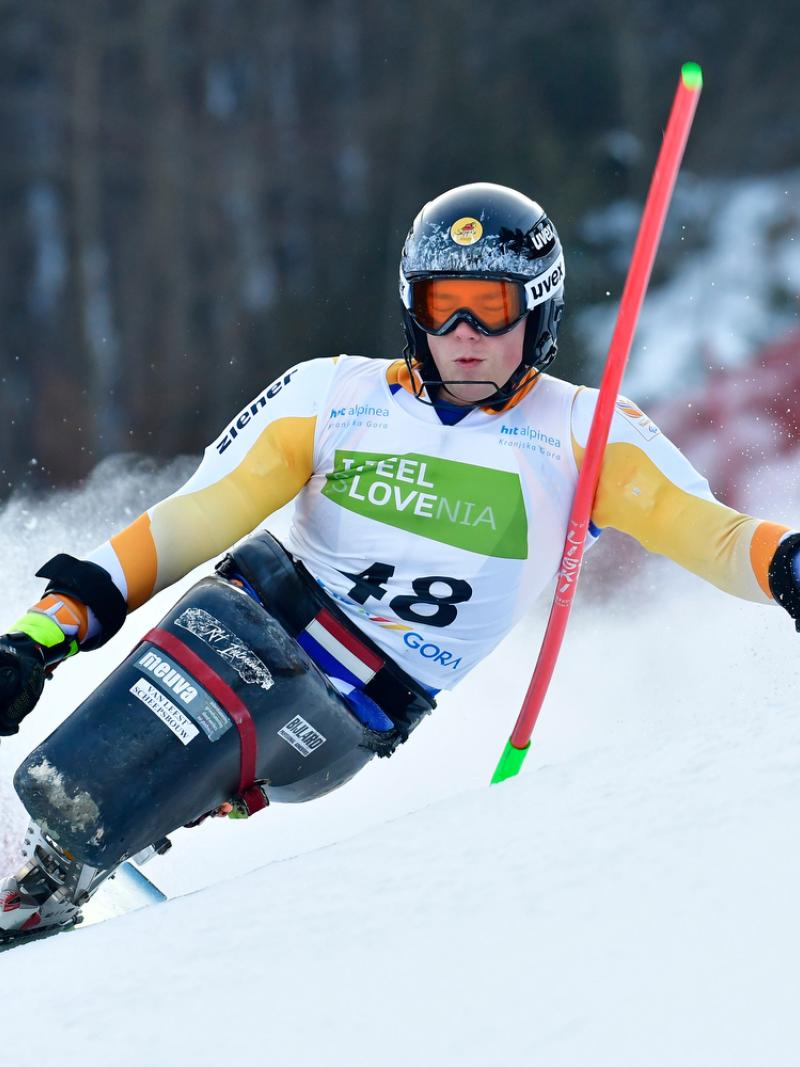 A male sit-skier competing on the snow