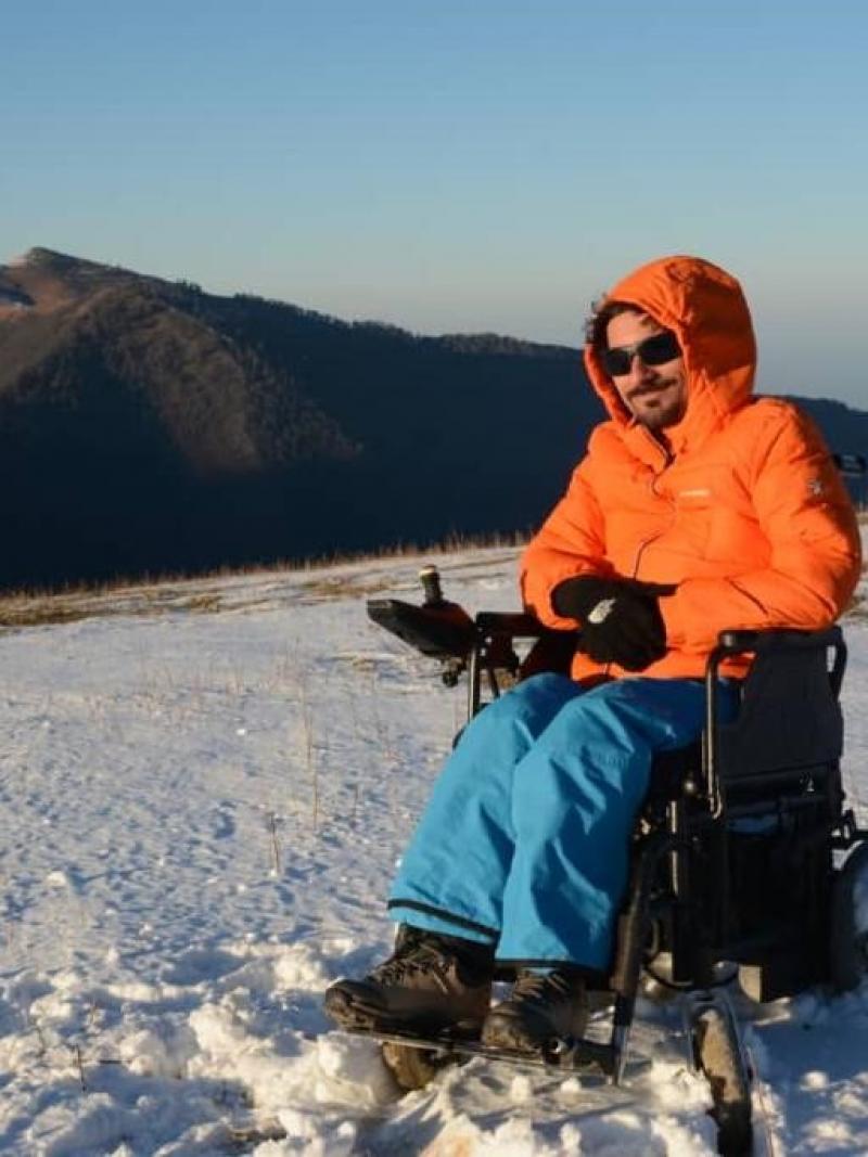 A man in an electric wheelchair on the snow