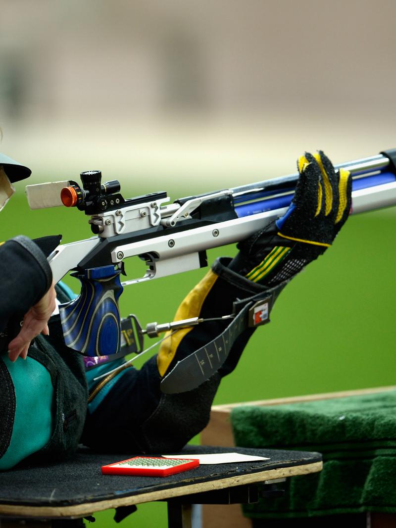 A woman competing with a rifle in a shooting range