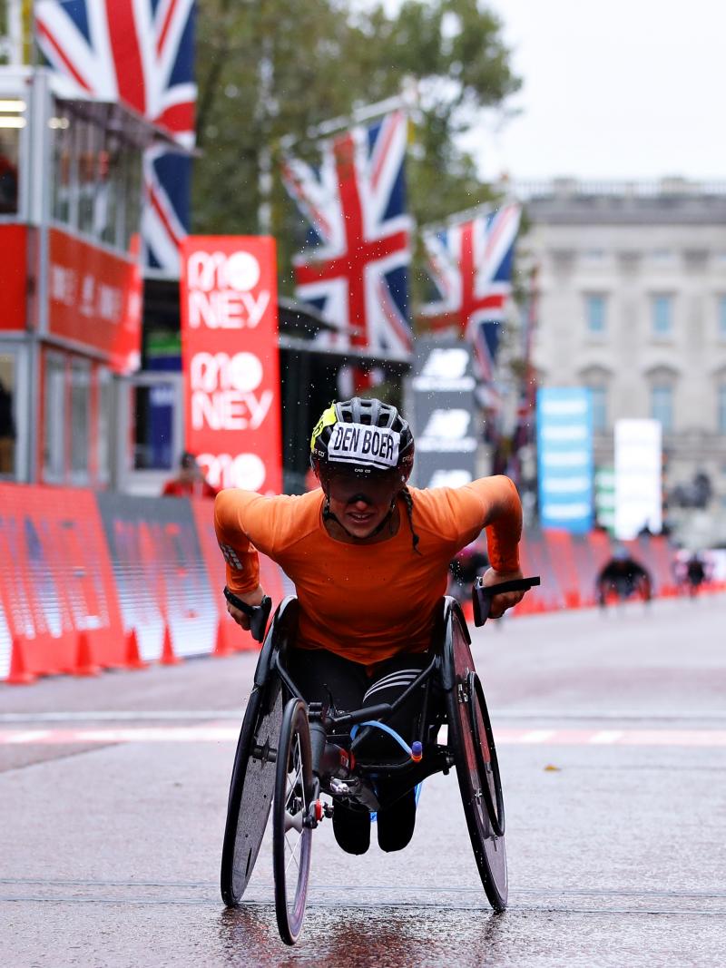 A female wheelchair racer crossing the line in the streets of London
