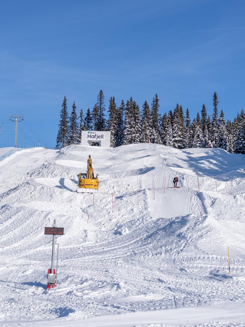 Three snowcats moving the snow to build a Para snowboard course