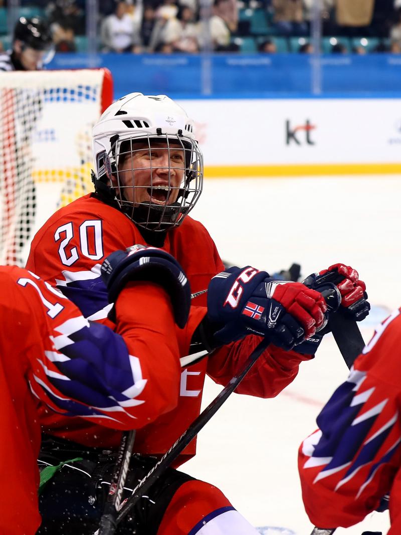 Three Norwegian Para ice hockey players celebrating on ice